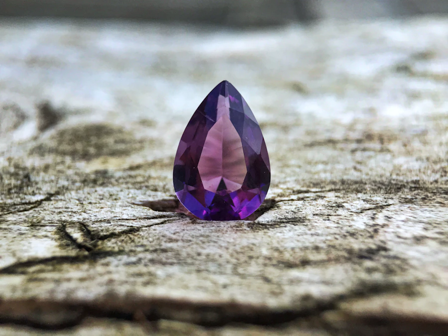 Teardrop amethyst on a weathered stone surface