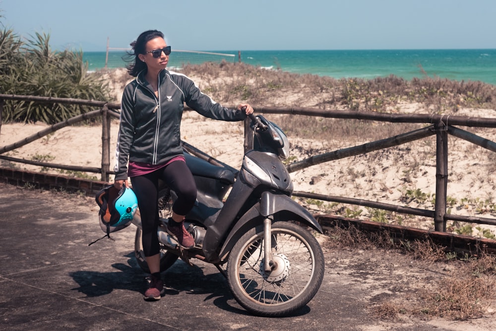 woman standing beside motorcycle