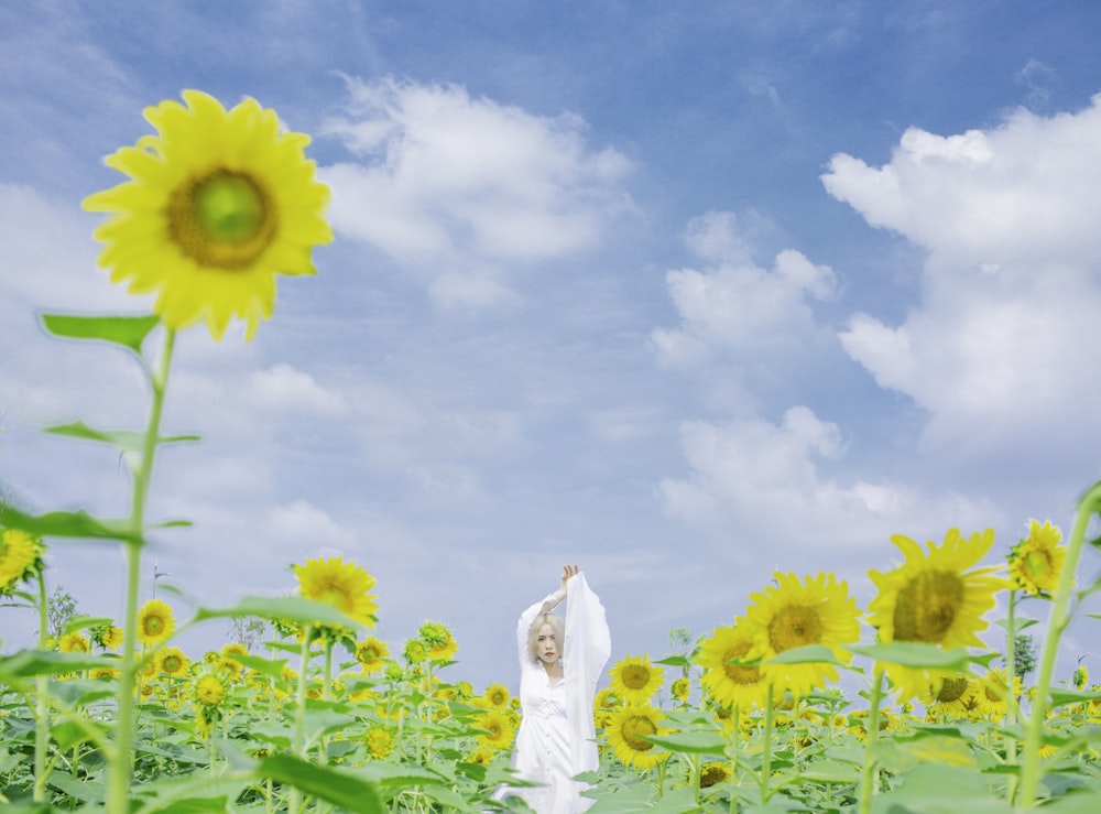 woman beside sunflowers