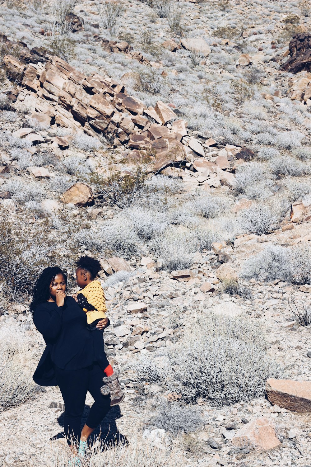 woman carrying girl