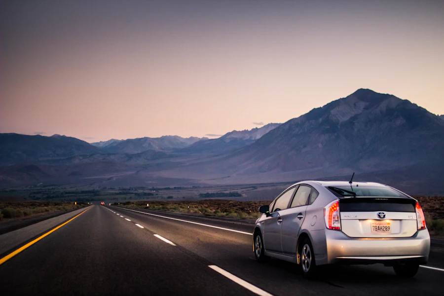 Car driving on an open highway at dusk
