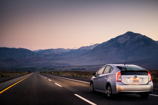 Car on a scenic road at golden hour during a weekend road trip