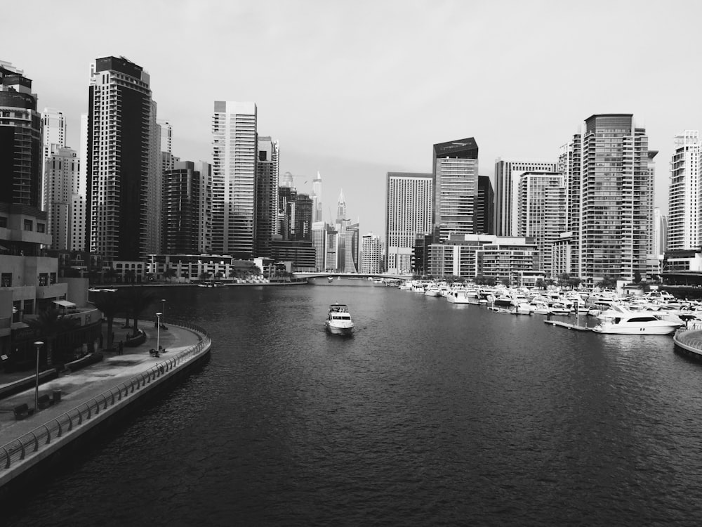 cabin cruiser on body of water near port and buildings