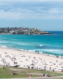 people on white sand beach at daytime