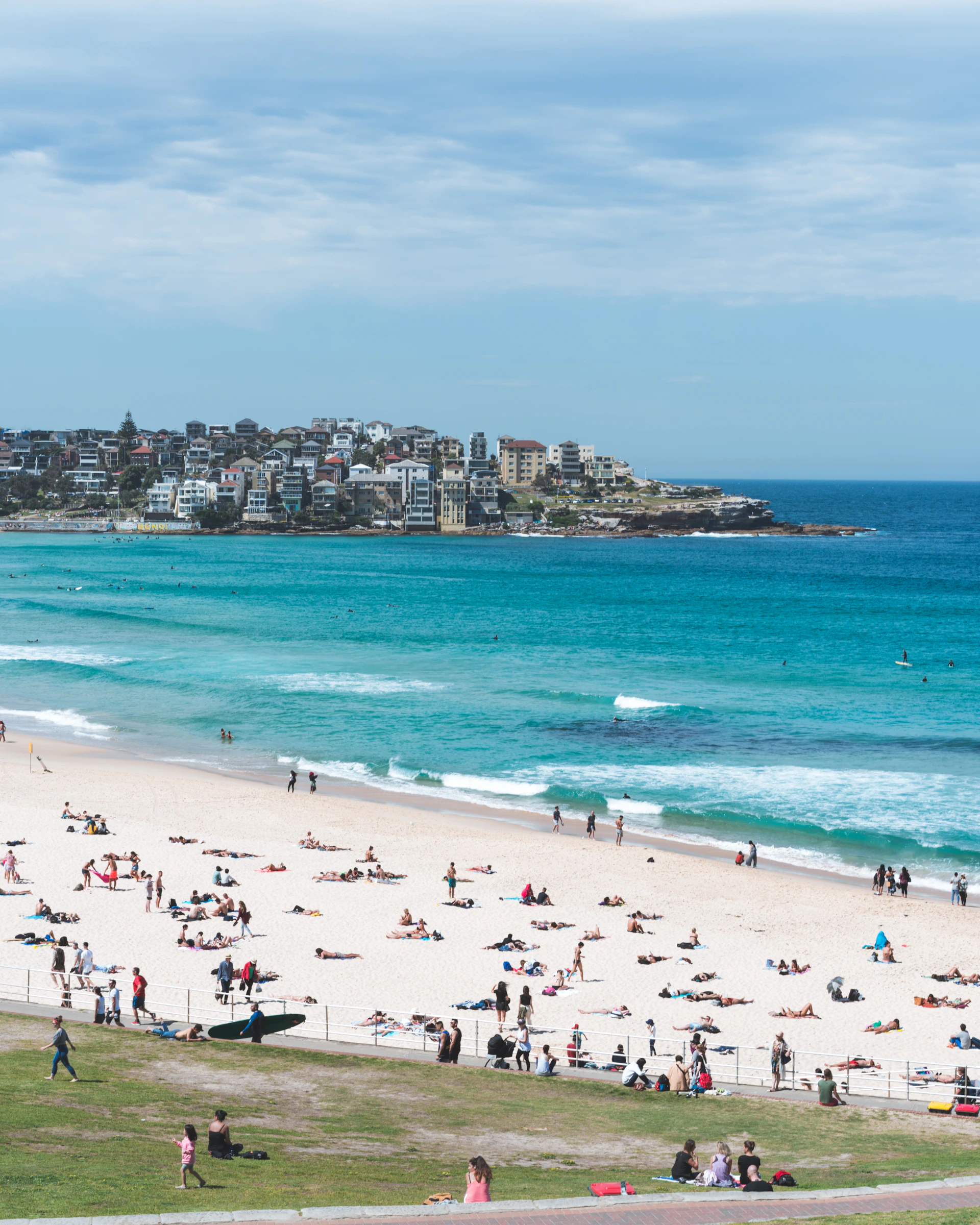 people on white sand beach at daytime