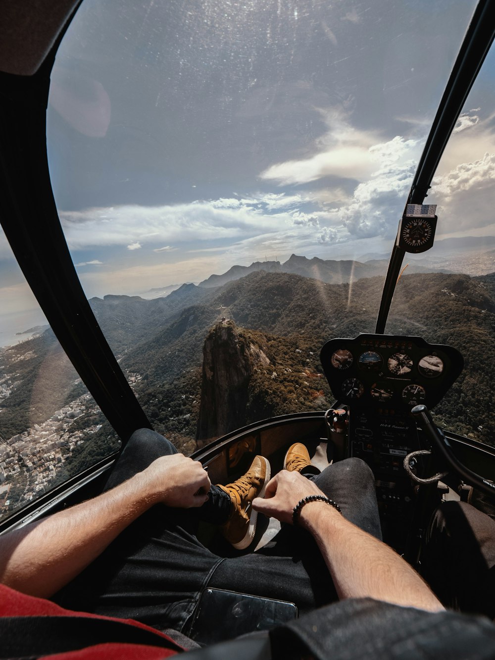 person riding aircraft over the mountain