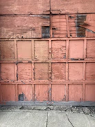 Before image of a worn-out wooden front door with peeling paint and visible damage.