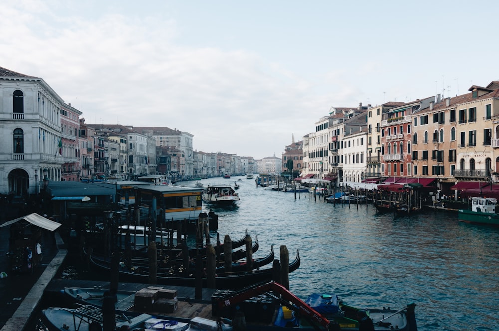 boats on water in between buildings during daytime