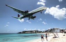 plane landing near seashore during daytime