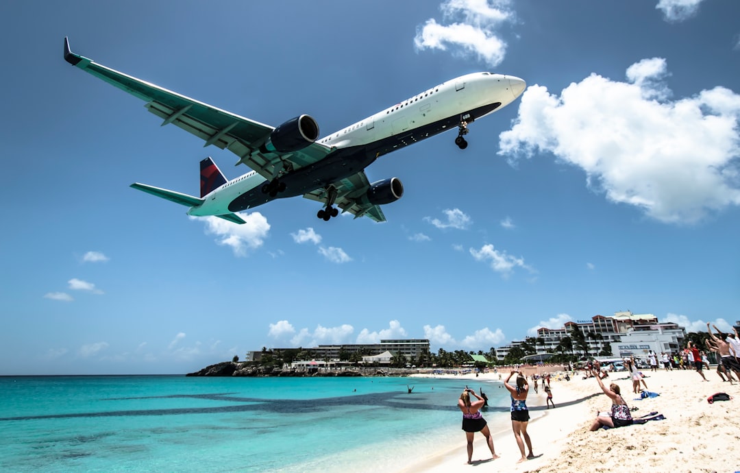 plane landing near seashore during daytime
