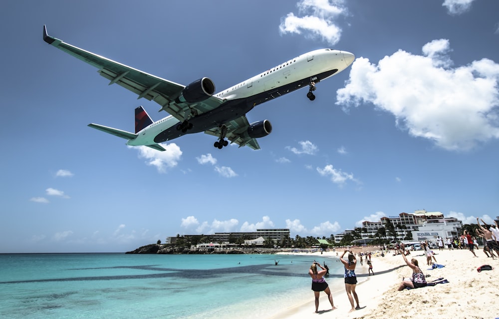 plane landing near seashore during daytime