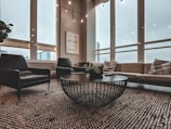 A modern living room featuring a sleek sofa and coffee table in natural light.