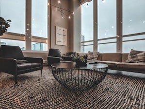 A modern living room featuring a stylish sofa and coffee table in natural light.