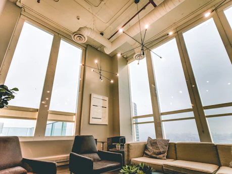 Relaxing lounge area with comfortable seating and natural light inside the studio