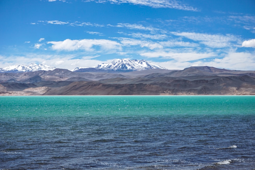 clear blue sea near mountain