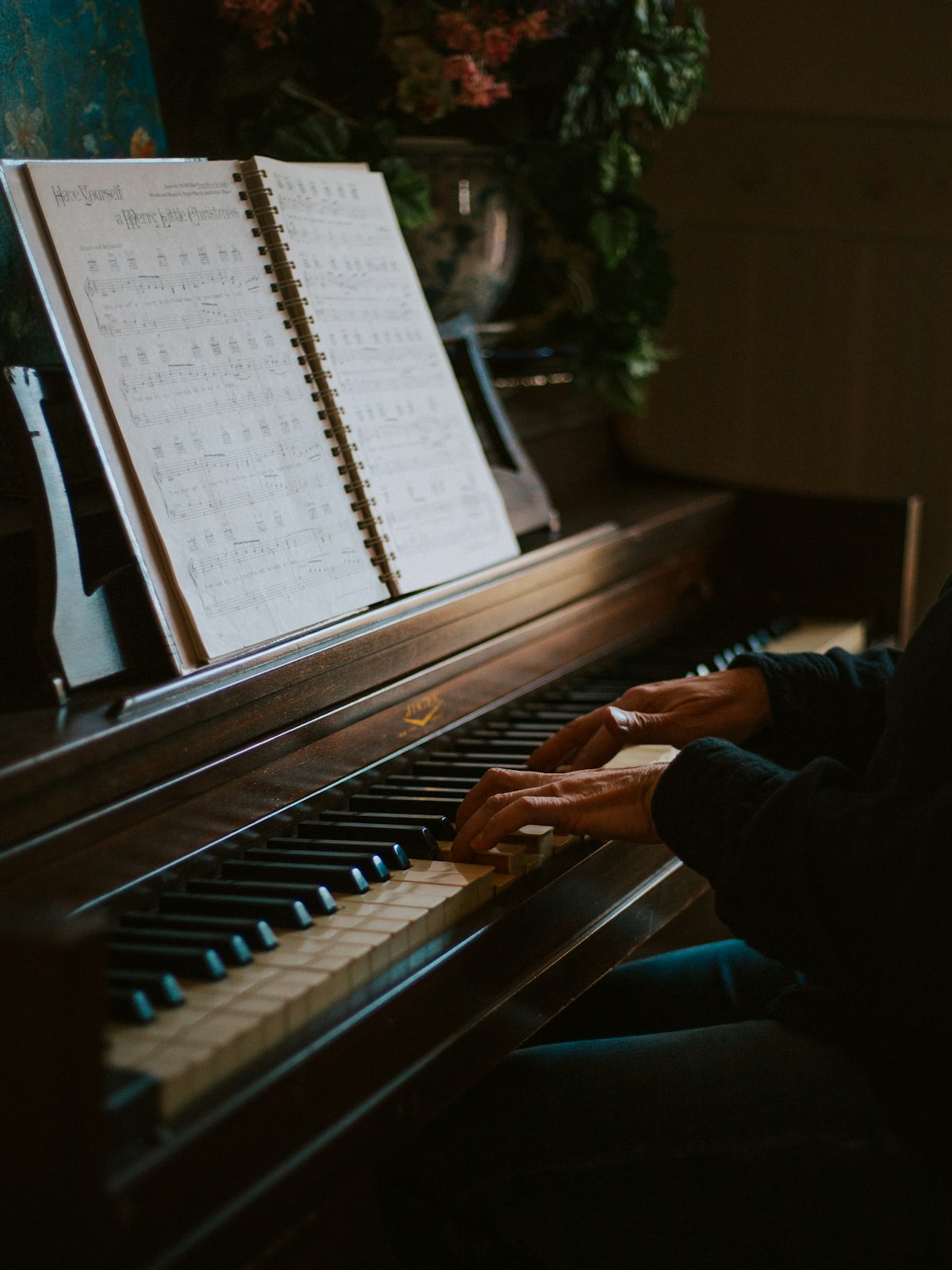 Music teacher composing at a piano with an open score, using AI tools for music teachers