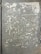 A weathered concrete surface with patches of peeling paint scattered throughout, showing irregular shapes and textures. Small debris and a few leaves are visible on the ground.