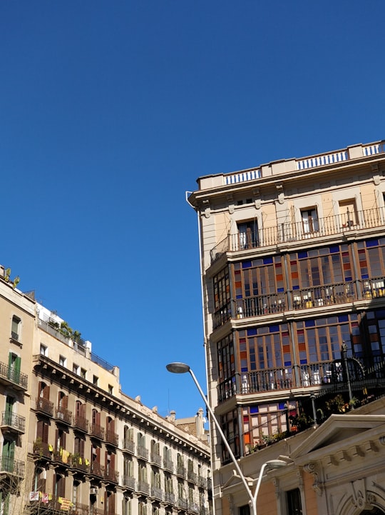 two high rise buildings under blue sky in Carrer del Consell de Cent Spain