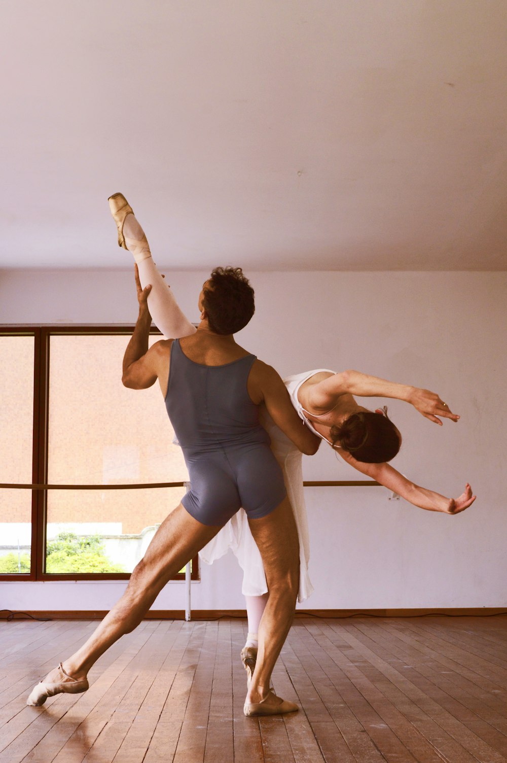 man and woman dancing inside building