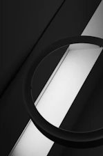 High-contrast abstract image of overlapping black and white geometric shapes with sharp edges.