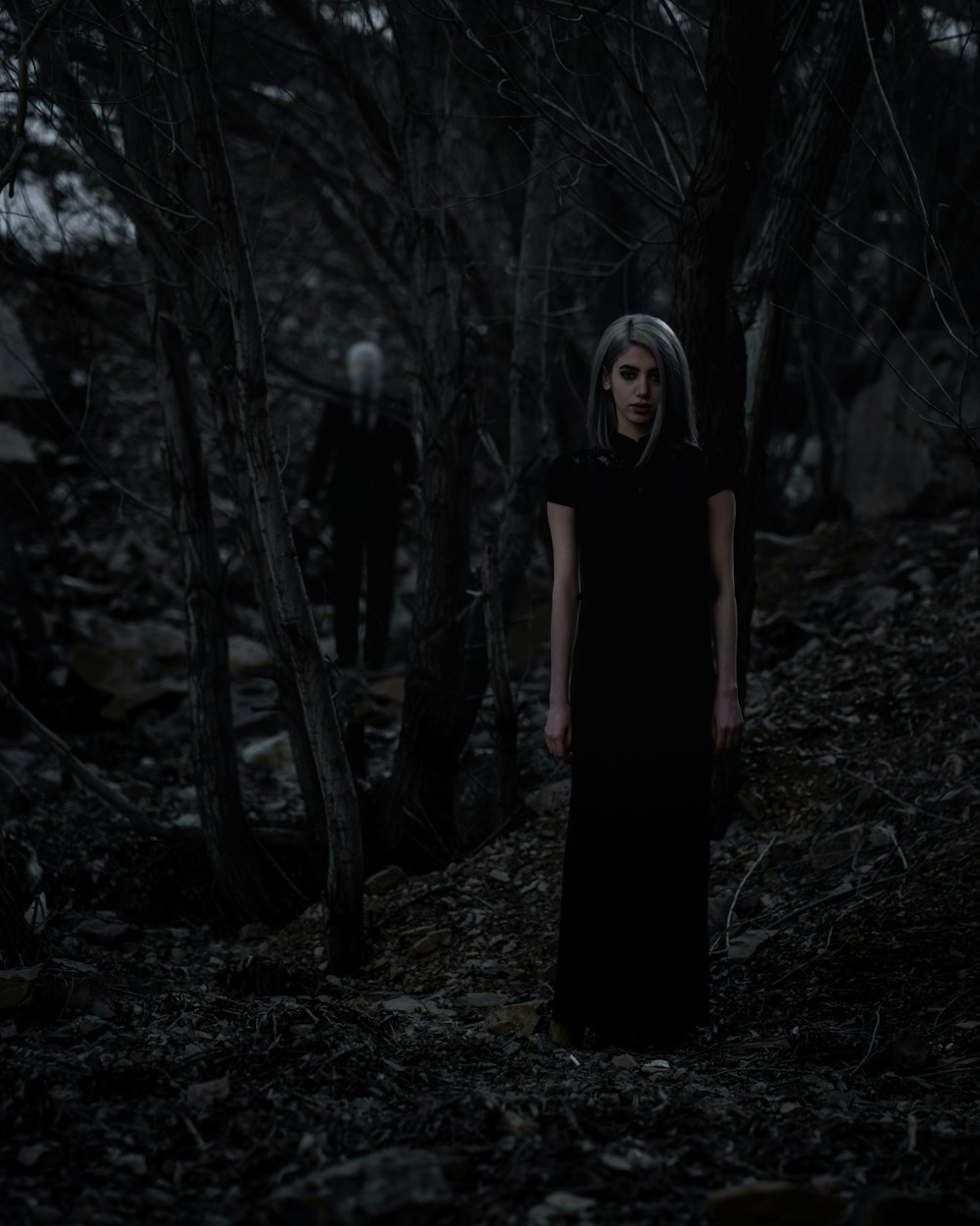 selective focus photography of woman standing on forest