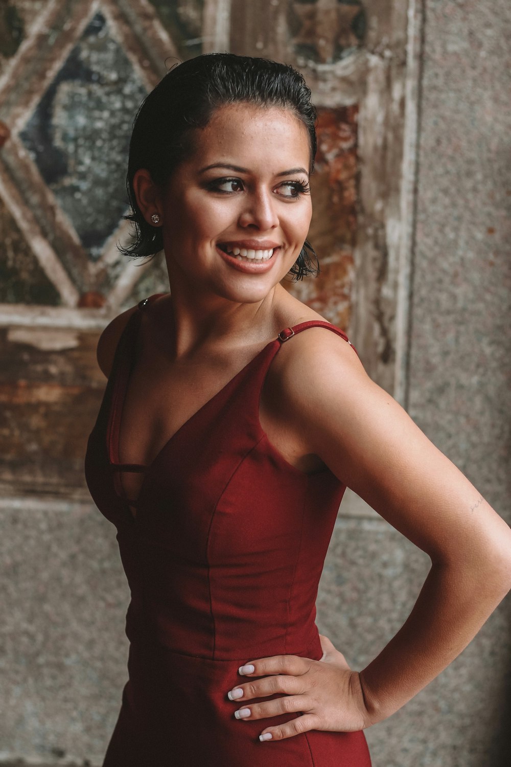 smiling woman wearing red V-neck sleeveless dress