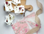 pink and green flower papers near brown wooden board