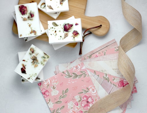 pink and green flower papers near brown wooden board