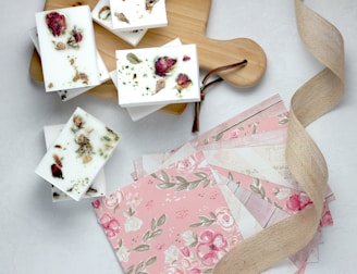 pink and green flower papers near brown wooden board