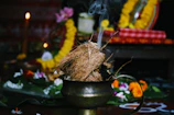 burning coconut husk on brass-colored pot