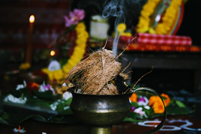 burning coconut husk on brass-colored pot
