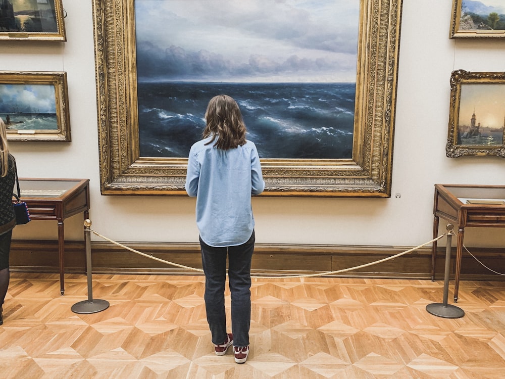 woman standing in front of paining