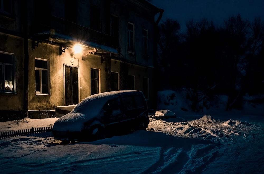 black vehicle parked outside near building during nighttime