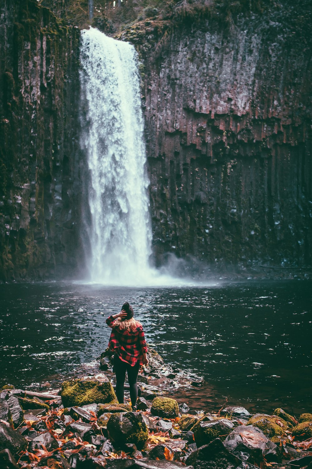 a person standing in front of a waterfall