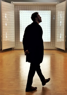 framing with frames for photo composition,how to photograph man in black coat standing inside room