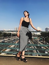 A confident woman smiling outdoors, symbolizing health and security.