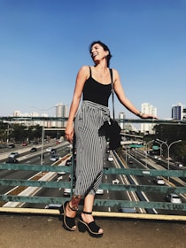 A confident woman smiling outdoors, symbolizing health and security.