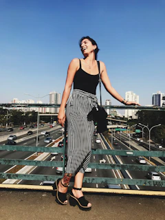 Smiling woman confidently going about her day, wearing casual clothes.