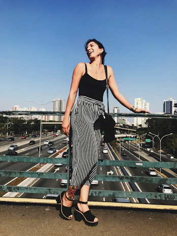 Smiling woman confidently going about her day, wearing casual clothes.