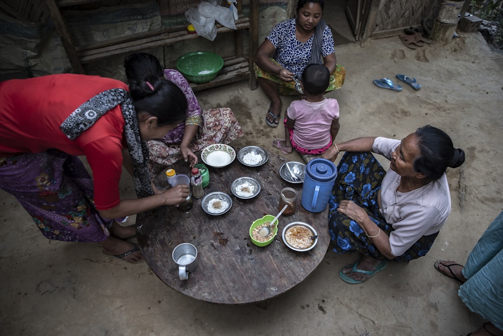 people sitting and eating outside during daytime