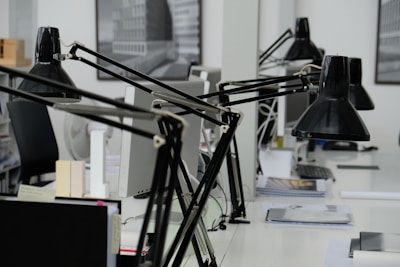 A professional office setting with a laptop and paperwork on a desk.