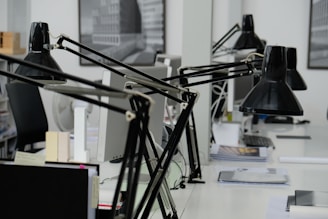 A professional office setting with a desk, laptop, and paperwork.