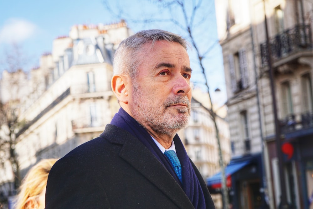 man wearing black notched lapel suit jacket