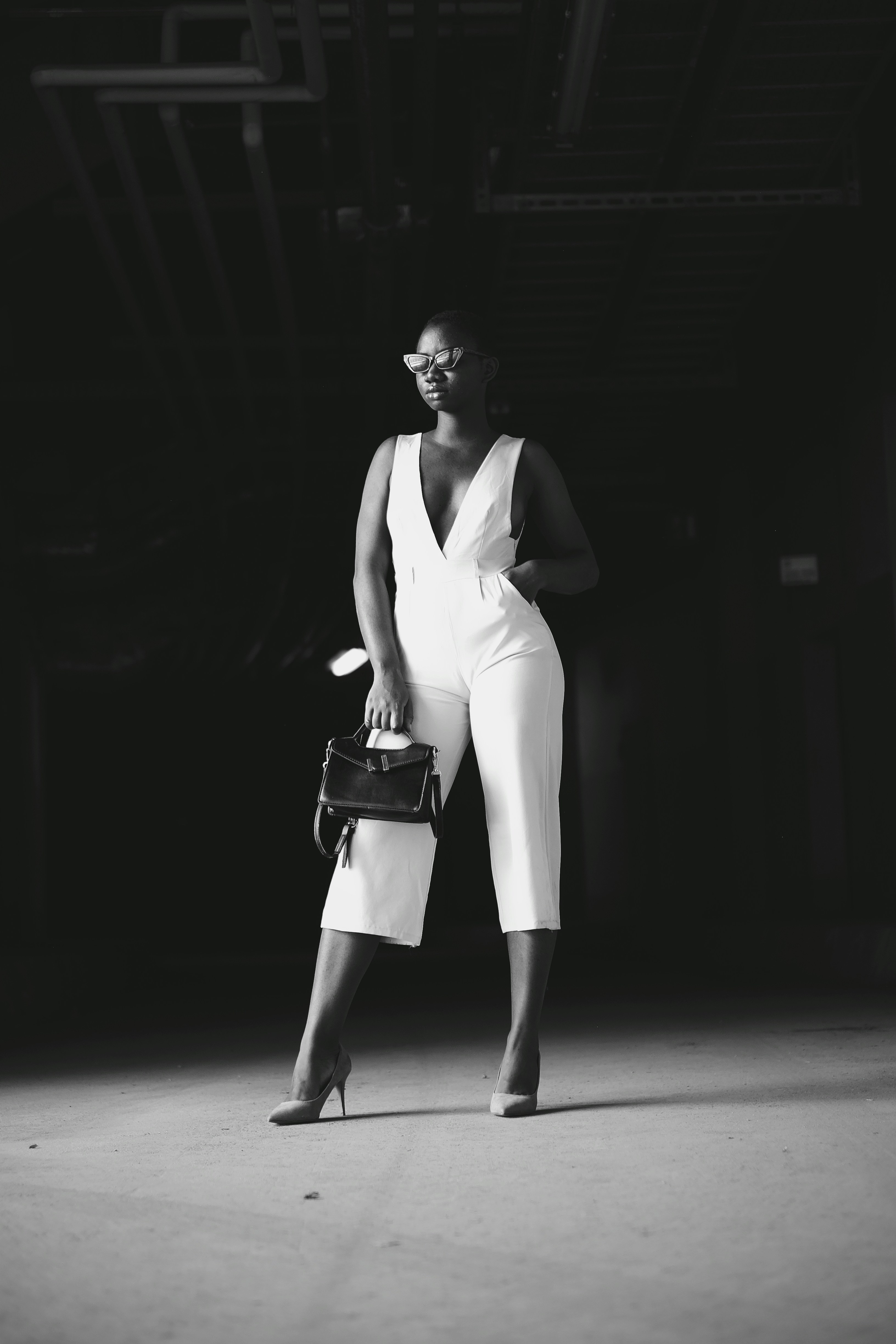 grayscale photography of woman holding handbag