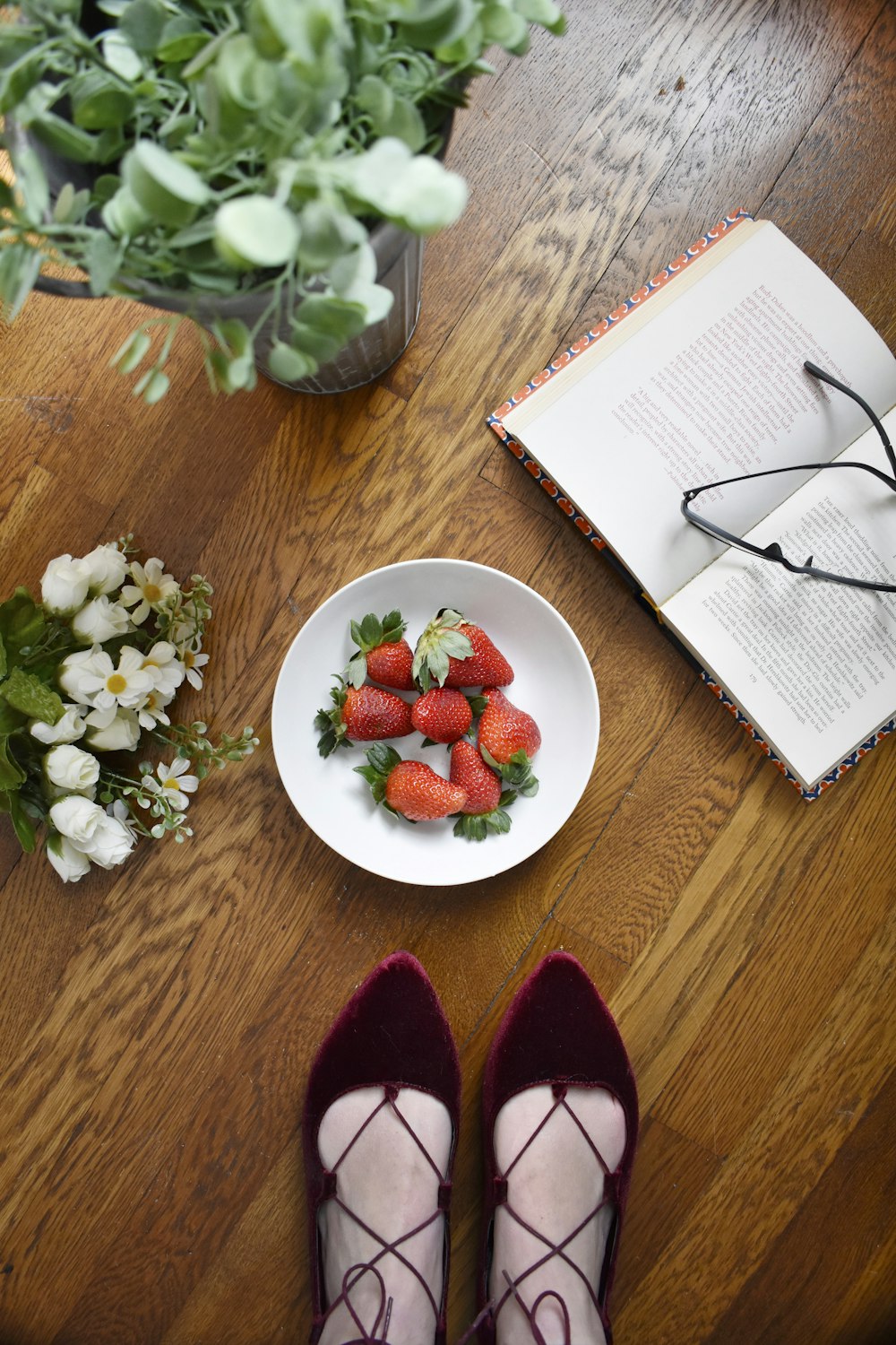 strawberries on bowl beside book