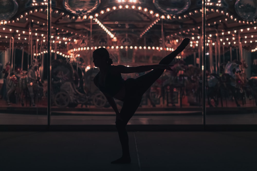 a person doing a trick in front of a carousel