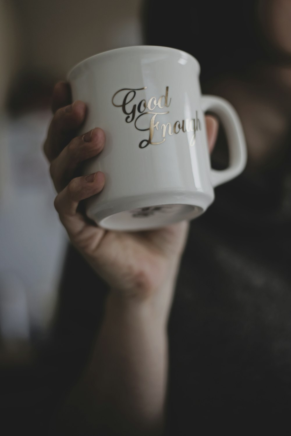 person holding white ceramic mug