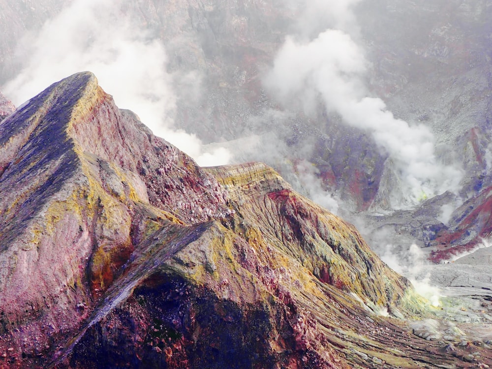 green and brown mountain under foggy weather during daytime