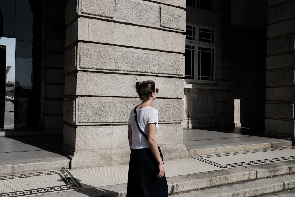 woman walking beside the building