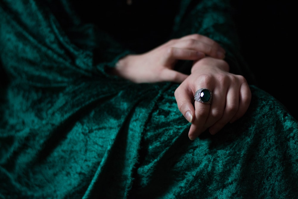 woman wearing green gemstone silver-colored ring